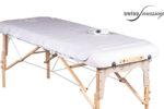 Couverture chauffante posée sur une table de massage pliable